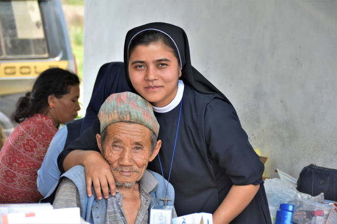 Sr. Tina with Patient, Health Camp along Rapti River